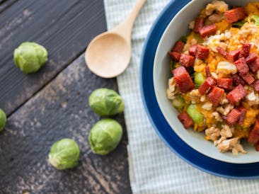 Sweet mashed potatoes with brussels sprouts, chorizo and walnuts