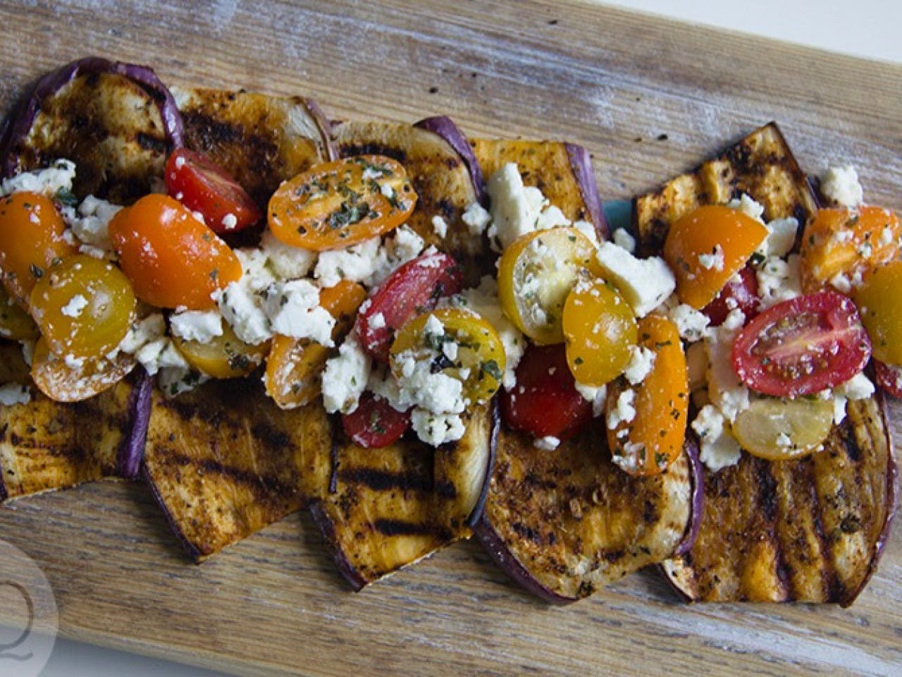 Grilled aubergine with tomato and feta