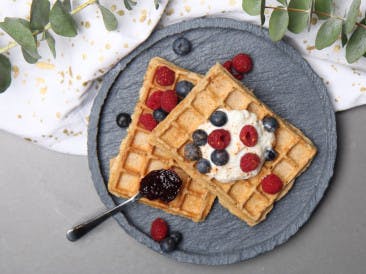 Delicious waffles with curd cheese and red fruit