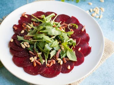 Red beet carpaccio with bacon strips