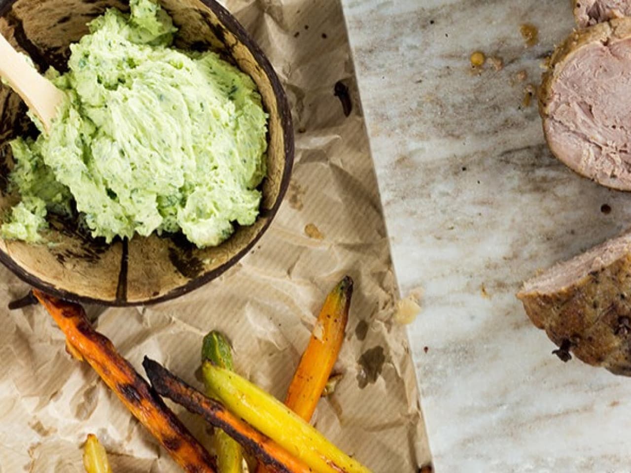 Pork roast with roasted vegetables and herb butter