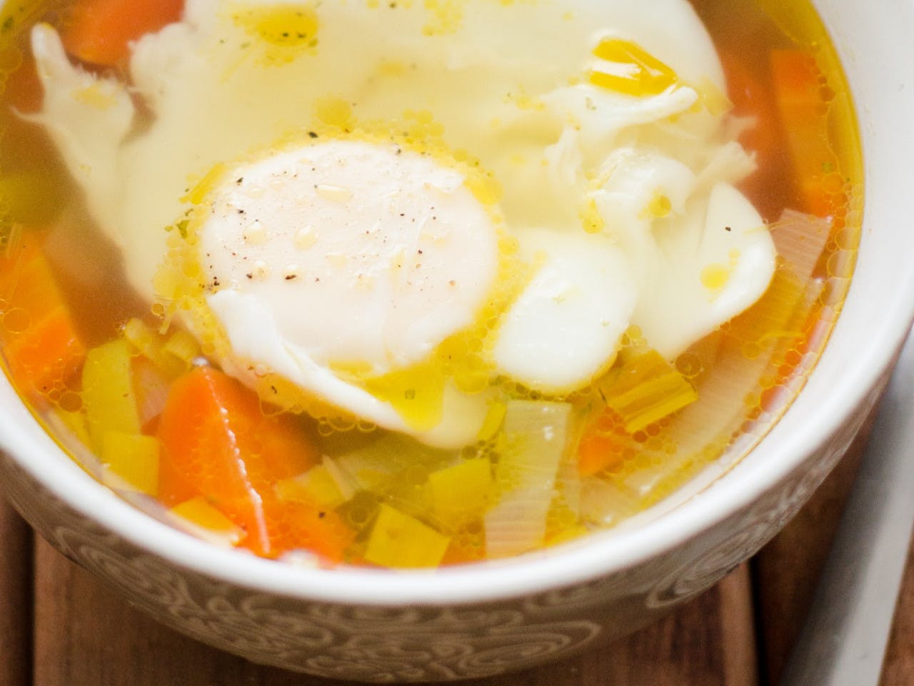Clear chicken soup with an egg