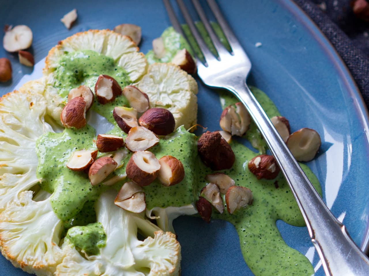 Cauliflower steaks with hazelnuts and herb sauce