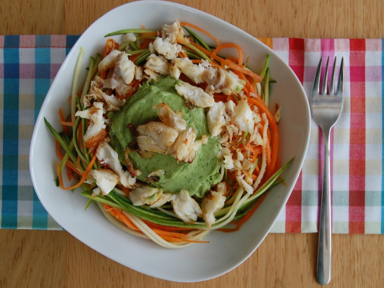 Zucchini carrot pasta with cod and avocado dressing