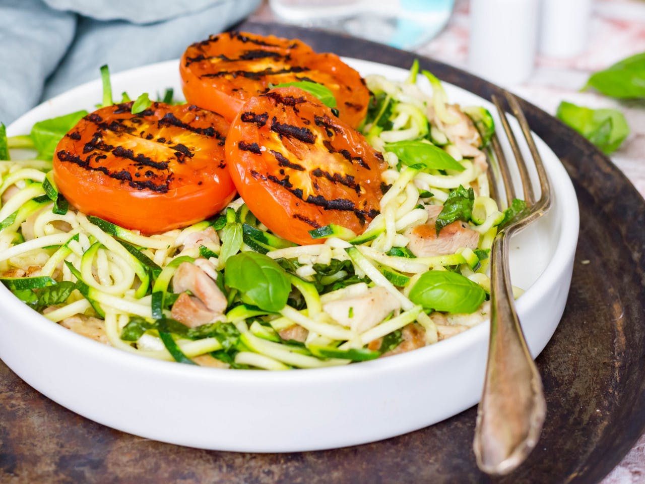 Zoodles with chicken thighs and grilled tomato