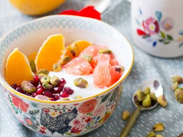 Coconut yogurt with citrus fruit and pistachio