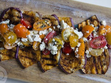 Grilled aubergine with tomato and feta