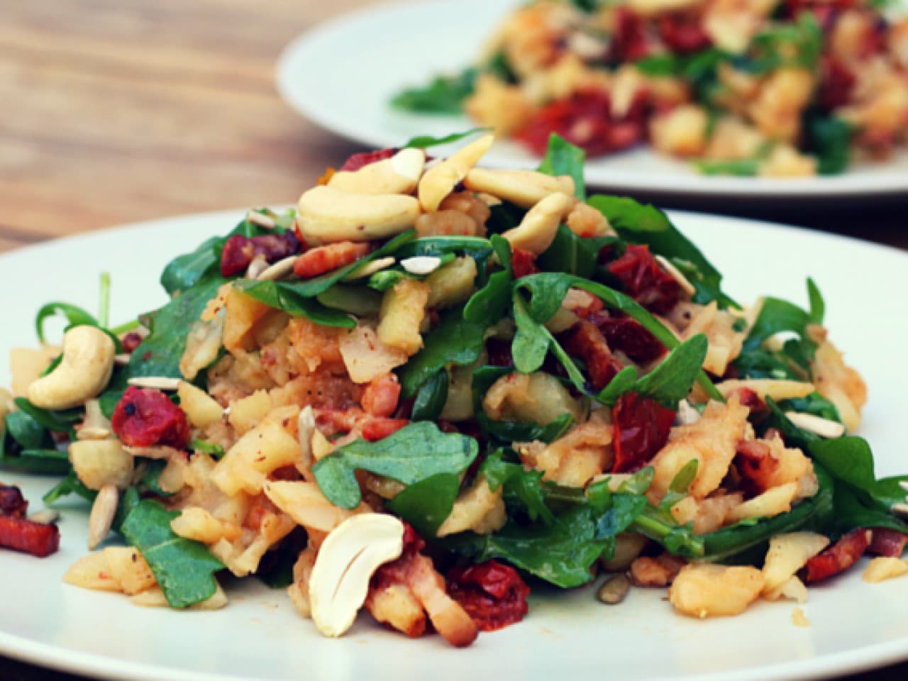 Arugula stew with sun dried tomatoes and bacon