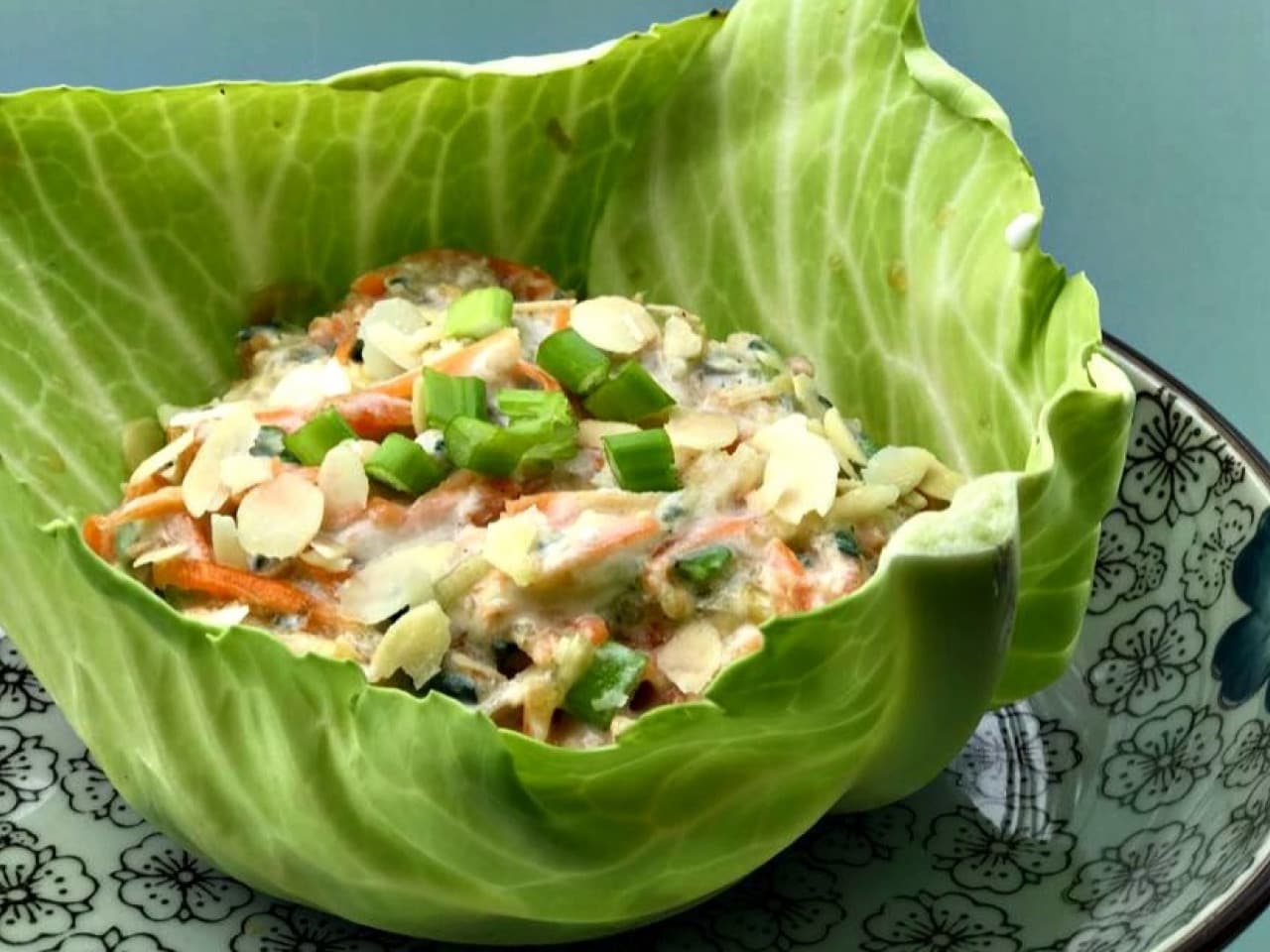 White cabbage boat with fresh apple carrot grater