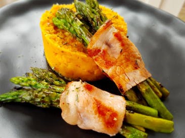 Green asparagus on a bed of sweet potato / parsnip puree