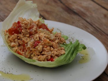 Lettuce boat with scrambled eggs and tomato onion