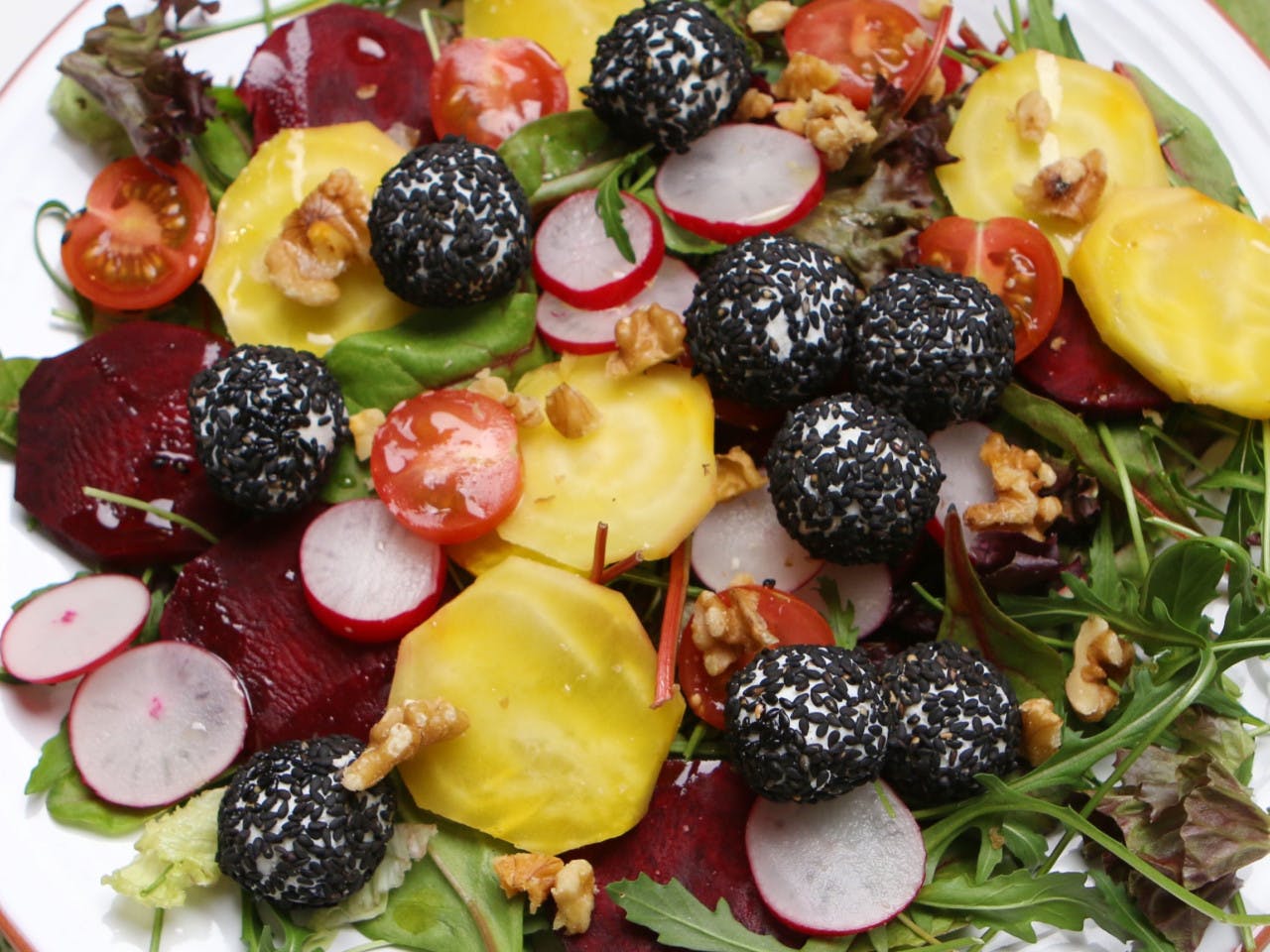 Colorful beetroot salad with goat cheese balls