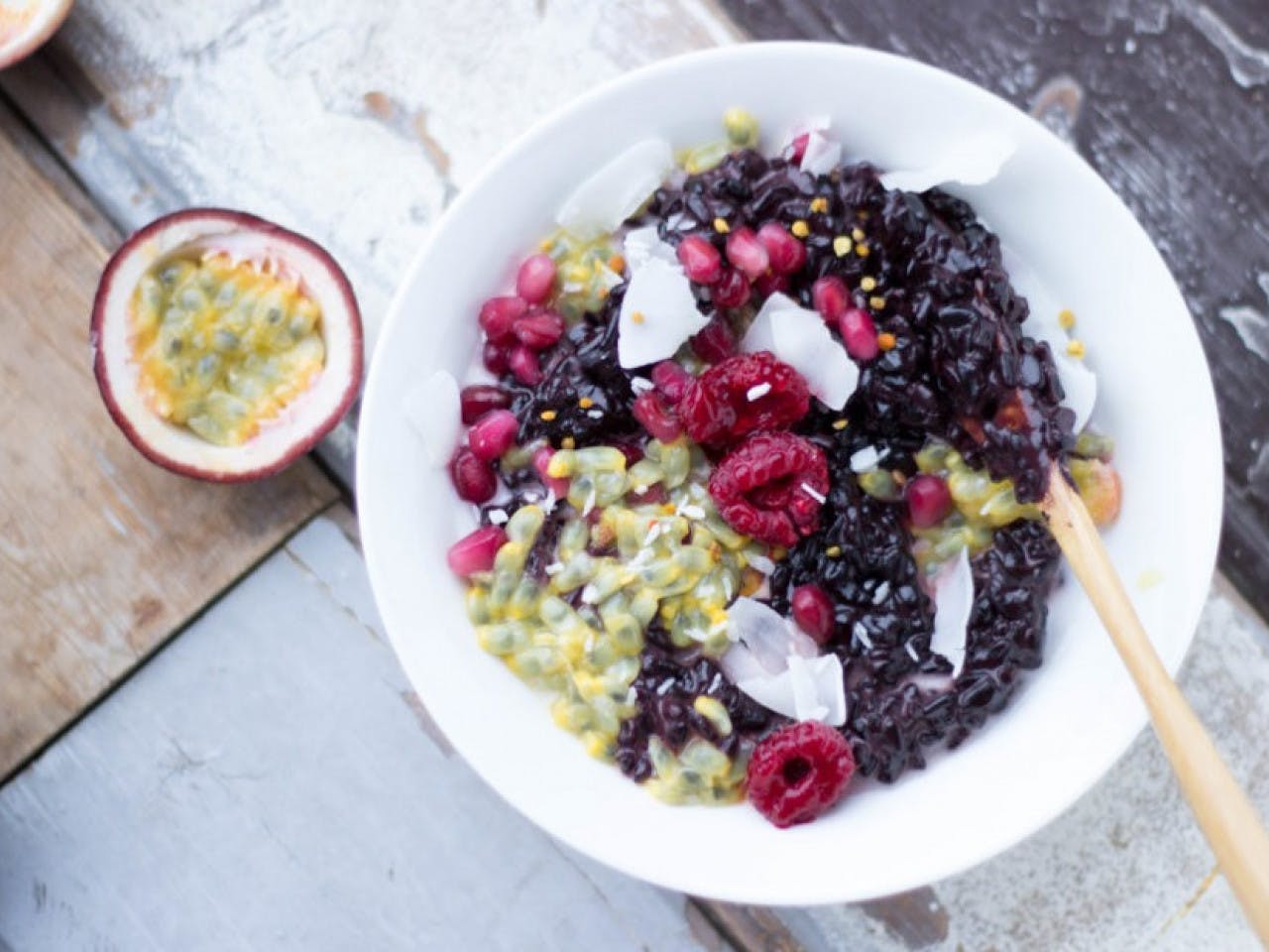Vegan black rice pudding with fruit, coconut and superfoods