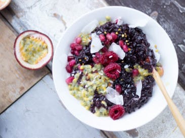 Vegan black rice pudding with fruit, coconut and superfoods