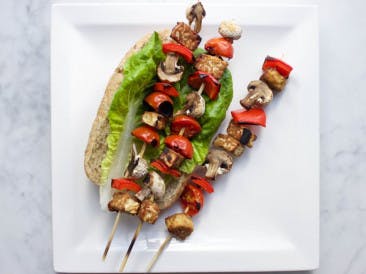 Vegan BBQ tempeh and mushroom skewers with romaine lettuce